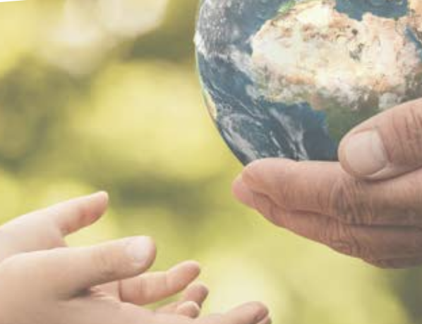 Older hands handing a 'world' to younger hands